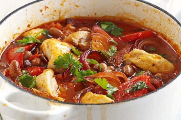 Smoky chicken and bean stew in a white cooking pot