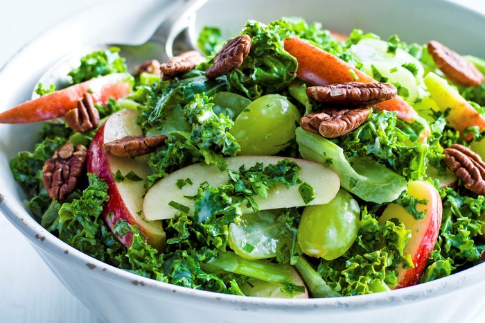 Kale waldorf salad with apple, pecans and celery