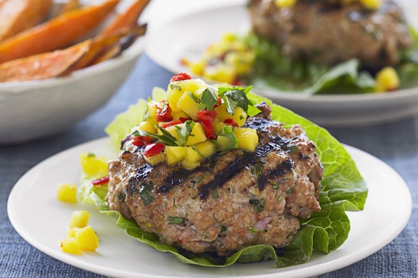 Thai Pork Burgers with Lettuce and Mango Salsa on a White Plate