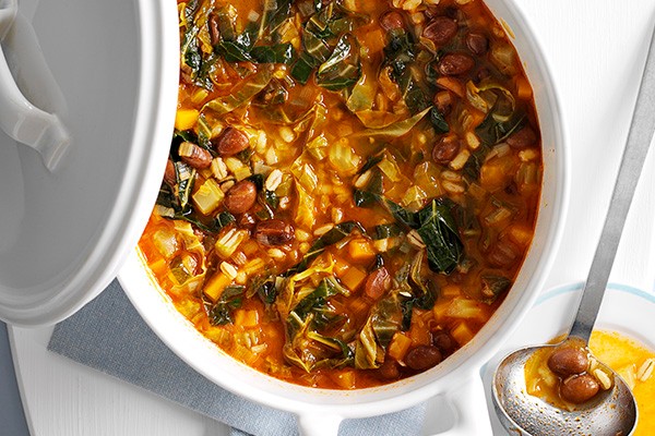 Bean and pearl barley stew in a white pot