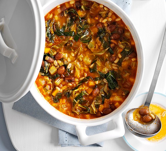 Bean and pearl barley stew in a white pot