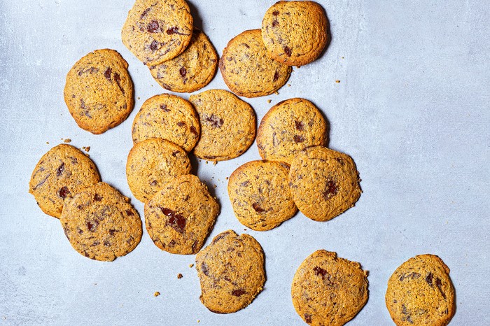 A light blue background topped with golden chocolate chip cookies