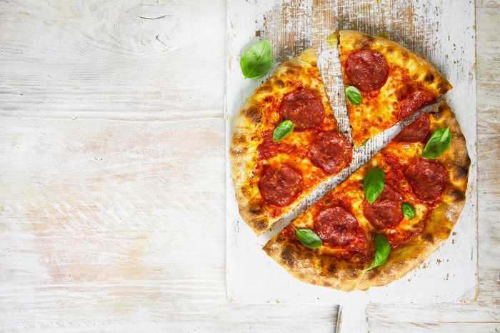 Homemade pepperoni pizza cut into four slices