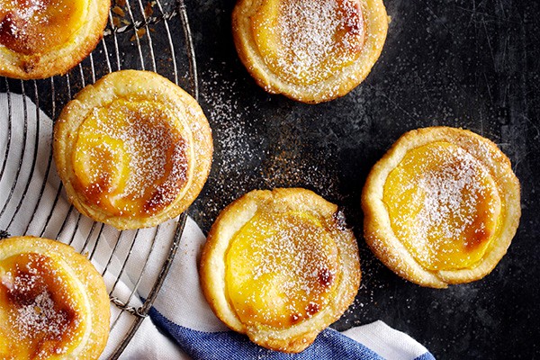 Portuguese custard tarts on a cooling rack