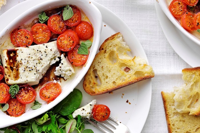 Baked feta with cherry tomatoes and garlic toast