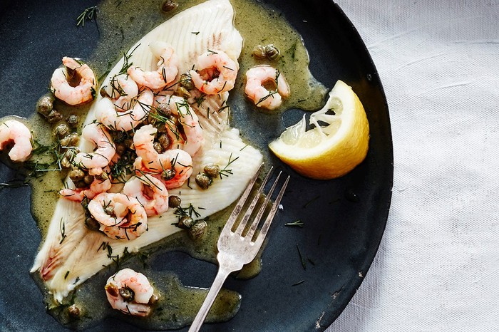 Plate with fillet of plaice topped with prawns