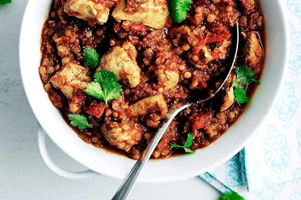 Bowl of chicken dhansak topped with coriander