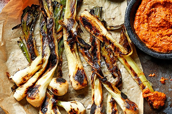 Tender spring onions with charred romesco