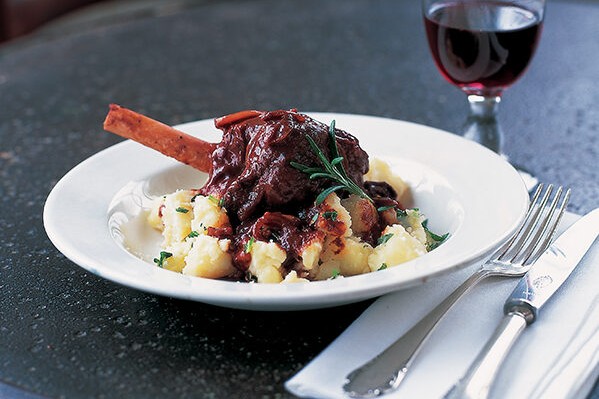 Braised lamb shanks with new potatoes on a plate