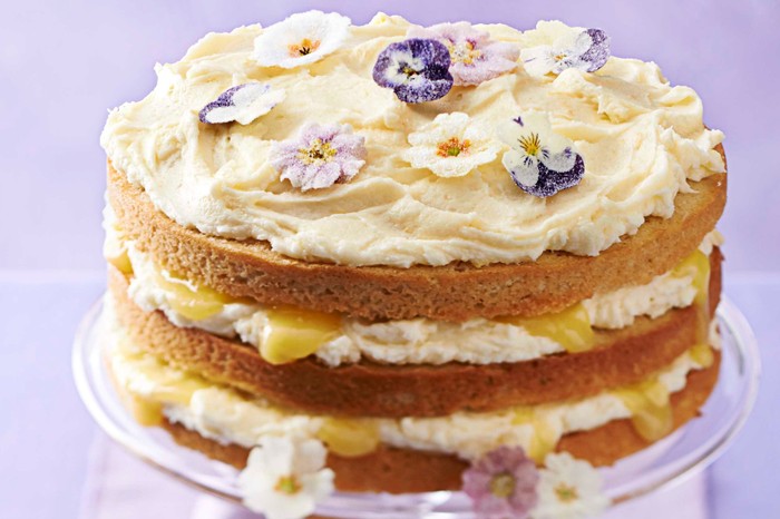 Lemon curd layer cake decorated with edible flowers