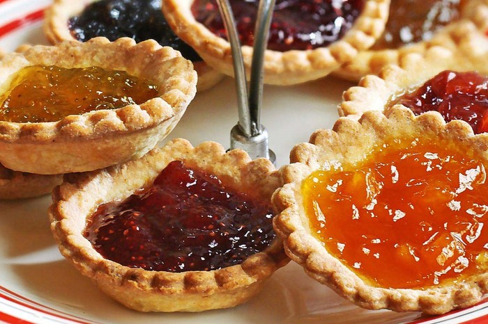 Jam Tarts Recipe Mini jam tarts on a serving plate, with multicoloured jam fillings