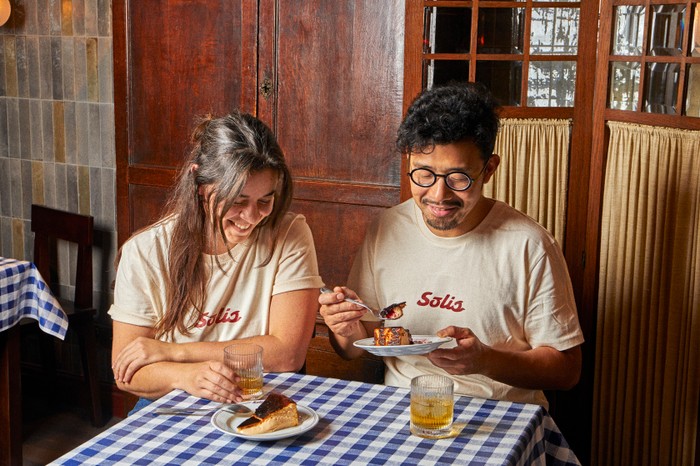 Solis, Battersea Solis owners Ana and Zijun sat at a table both tucking into a plate of cheesecake