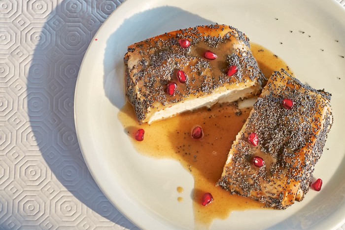 Feta block wrapped in filo pastry topped with poppy seeds and covered in honey and tahini