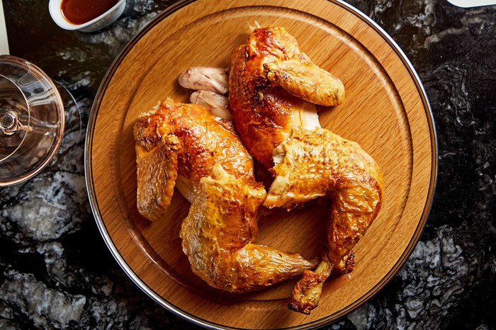 A Rotisserie chicken on a wooden board