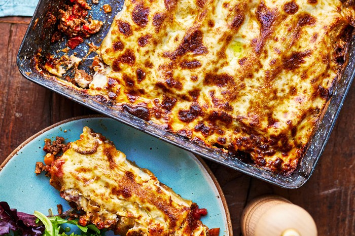 Beef cannelloni in a baking dish and served on a plate