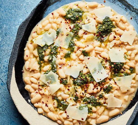 Cannellini beans topped with minty sauce and parmesan shards