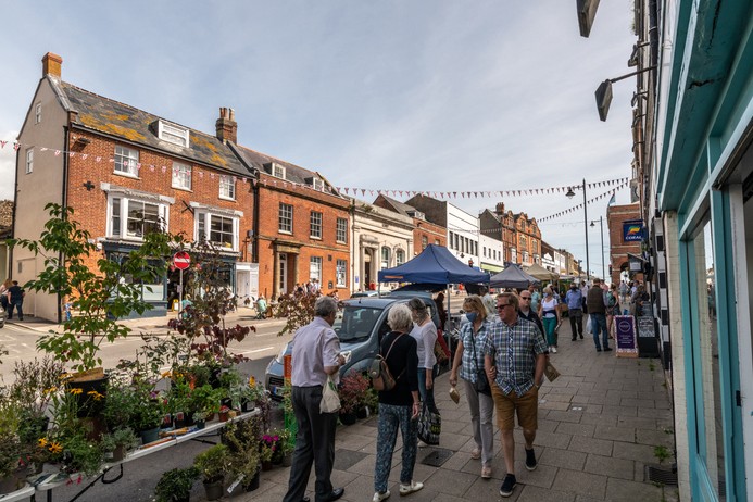 Bridport, UK. Saturday 12 September 2020. People walking and looking at the Street market stalls in Bridport, Dorset.