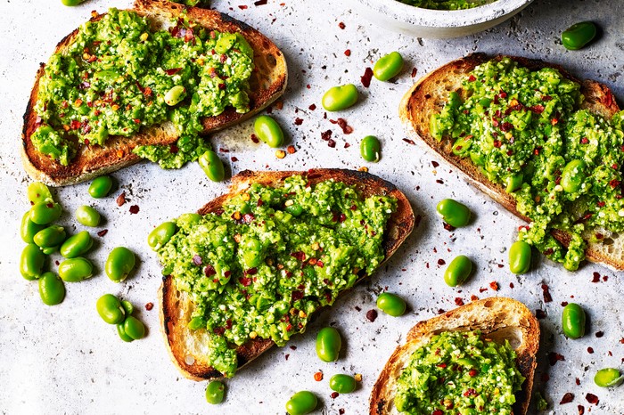 Smashed Broad Beans on Toast Several pieces of toast with smashed broad beans spread over them
