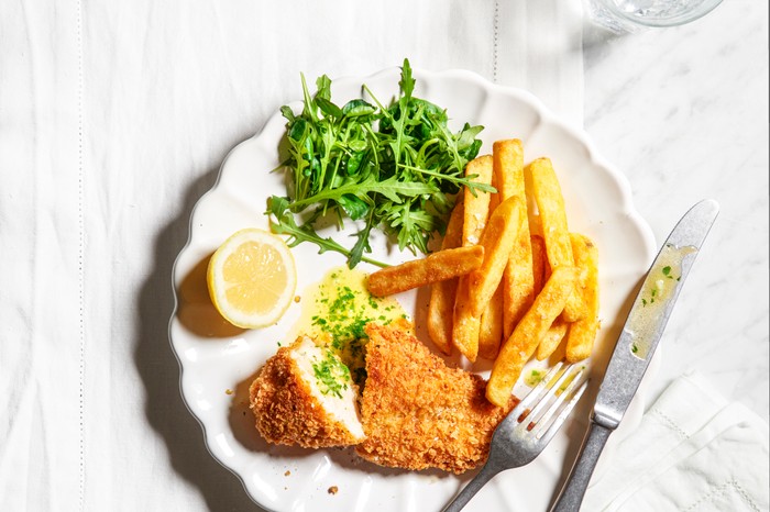 Chicken kiev with chips and greens