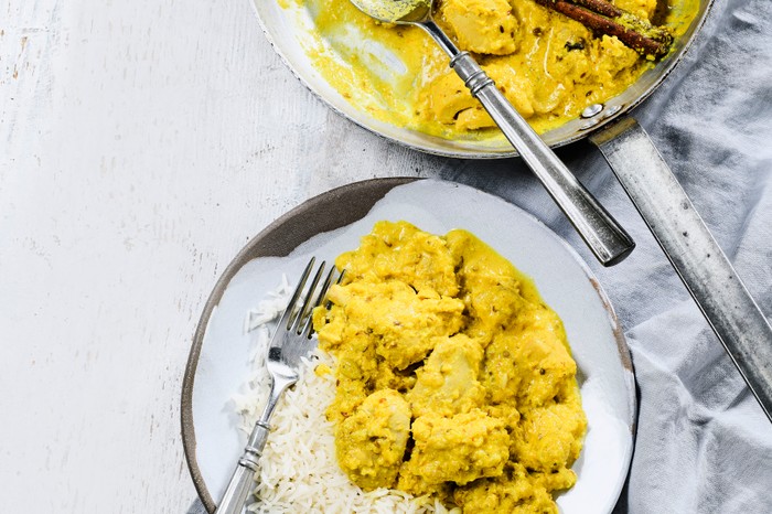 Plate and pan of chicken korma with rice