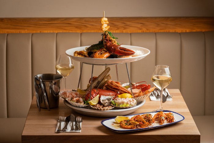 Fruits de mer Fruits de mer, served with a side of prawns and two glasses of white wine