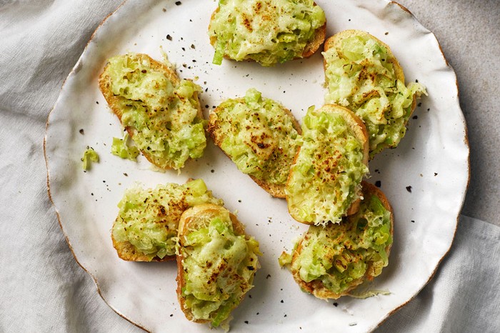 Eight slices of toast covered in leek on a large plate