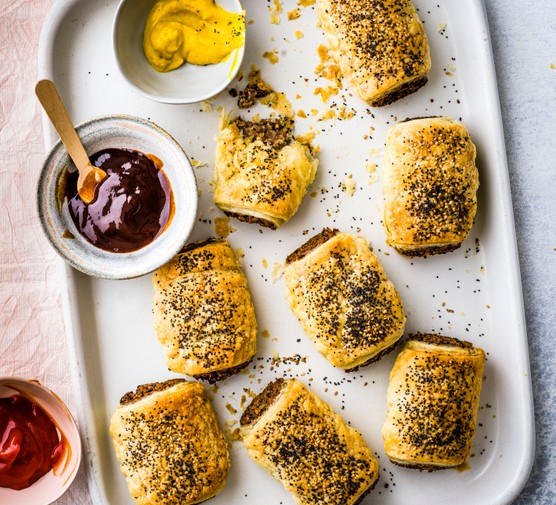 Vegan Sausage Rolls on a Baking Tray with BBQ Sauce for Dipping