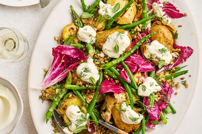 A tray of whipped feta, roast smashed potato and grain salad