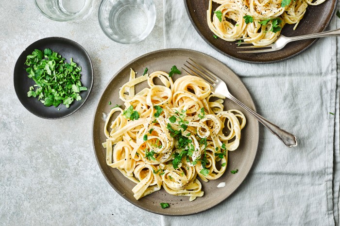 Two plates of Fettuccine Alfredo