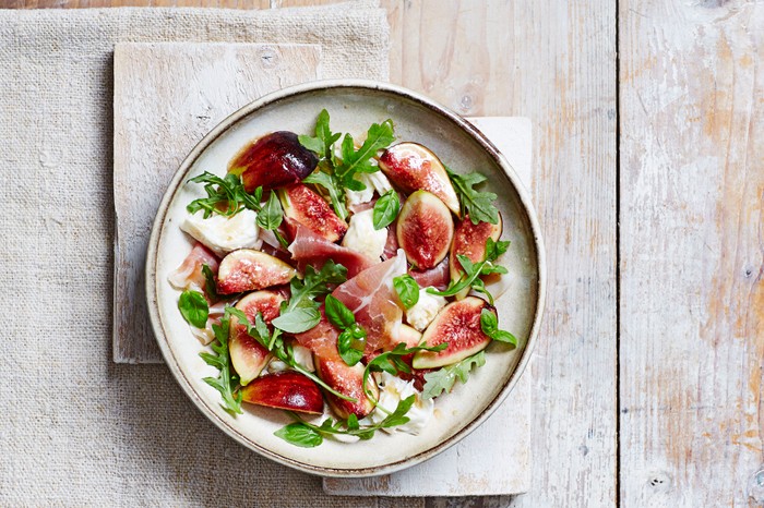 Figs, mozzarella, and serrano ham salad on a plate