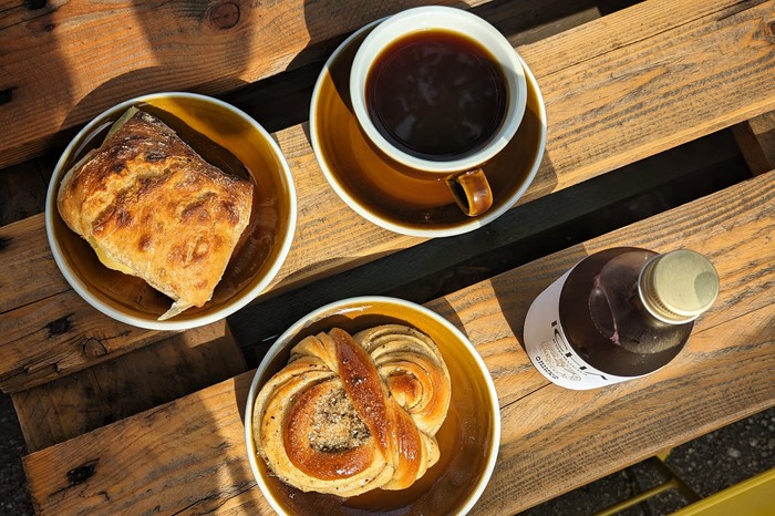 Cinnamon buns and two coffees on a sunfilled table at Svedjans Bageri Stockholm