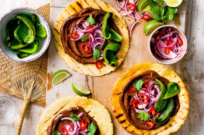 Tacos loaded with grilled peppers, chillies and mole sauce