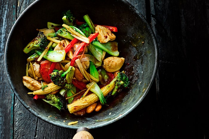 Ginger chicken and vegetable stir-fry in a wok