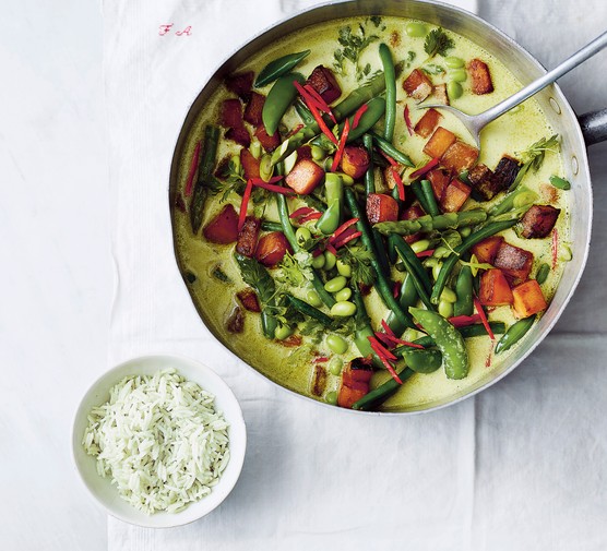 Vegan Thai Green Curry in a skillet next to a bowl of rice