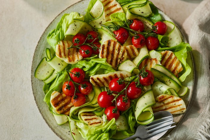 A salad of grilled halloumi, courgette ribbons and cherry tomatoes