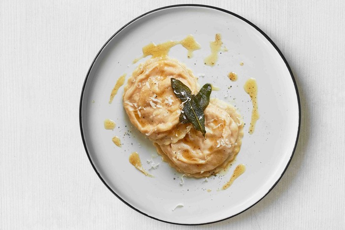 Two pieces of butternut squash ravioli on a plate