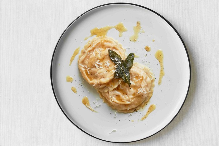 Butternut squash ravioli Two pieces of butternut squash ravioli on a plate