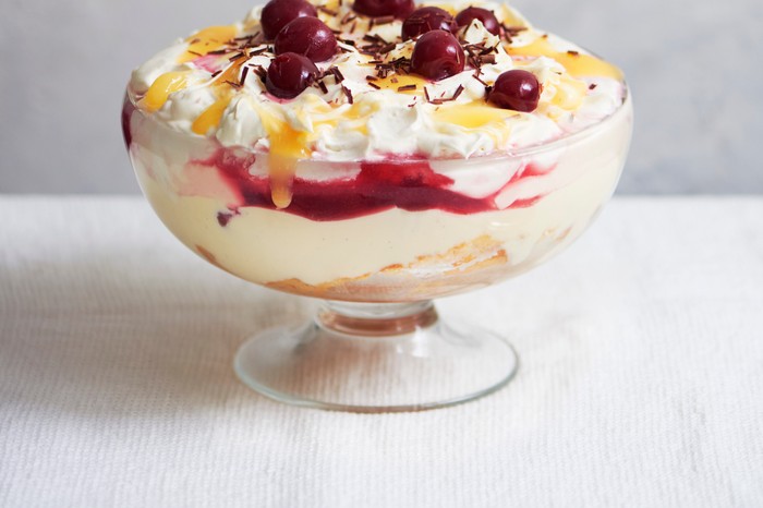 A large lemon trifle topped with cherries