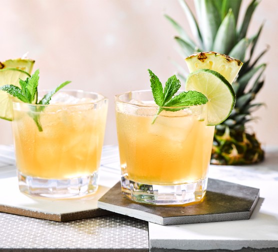 Two mai tai cocktails topped with fresh mint