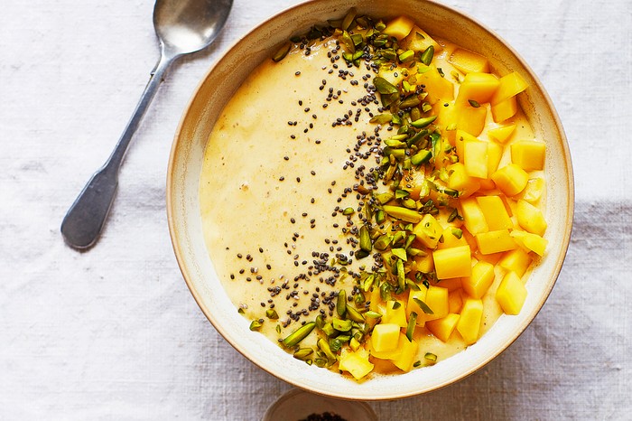 Mango Smoothie Bowl with Chunks of Fresh Mango and Seeds