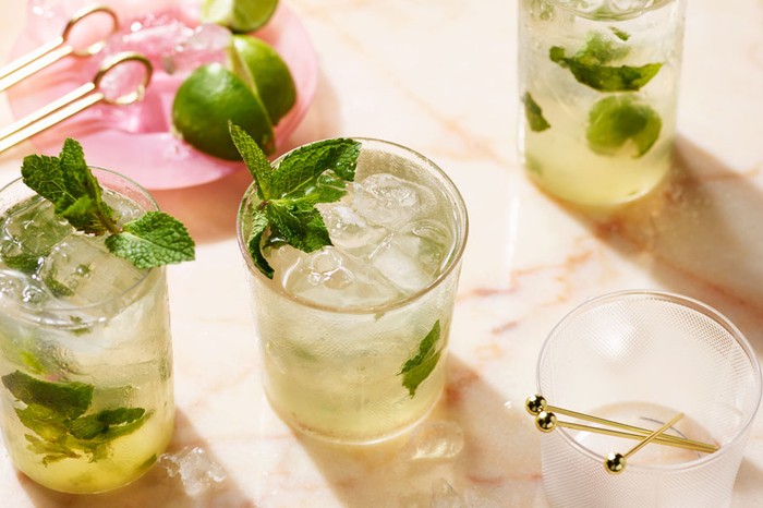 Mojito Recipe Three glasses of mojito, filled with ice, limes and garnished with mint leaves