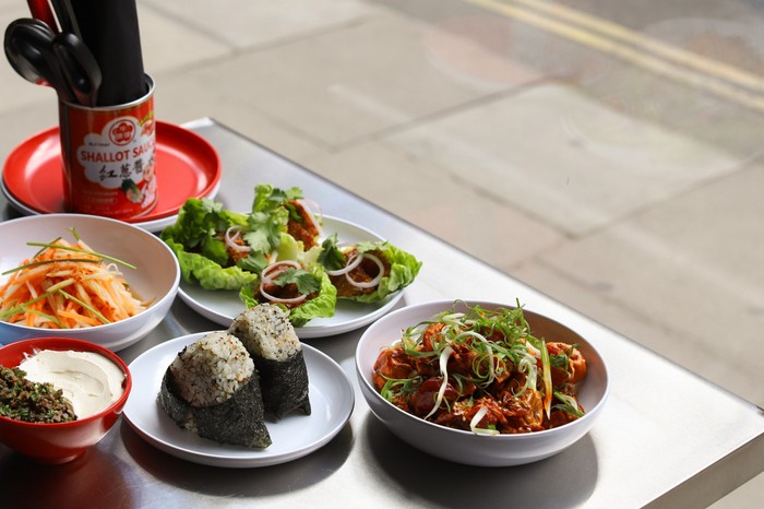 Mr Ji small plates A selection of small plates and chicken dishes on an table outdoors