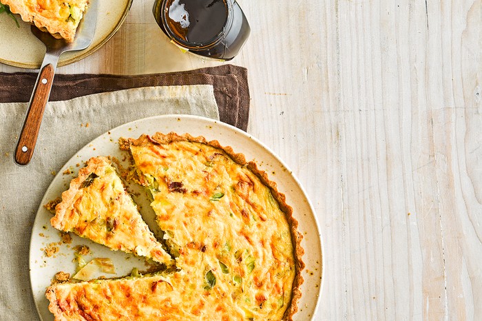 Bacon, cheddar and leek quiche with Marmite pastry A quiche on a plate with one slice ready to be served