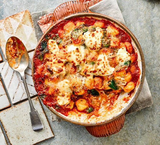 Tomato, spinach and mascarpone gnocchi Tomato, spinach and mascarpone gnocchi in a circular dish, next to a serving spoon