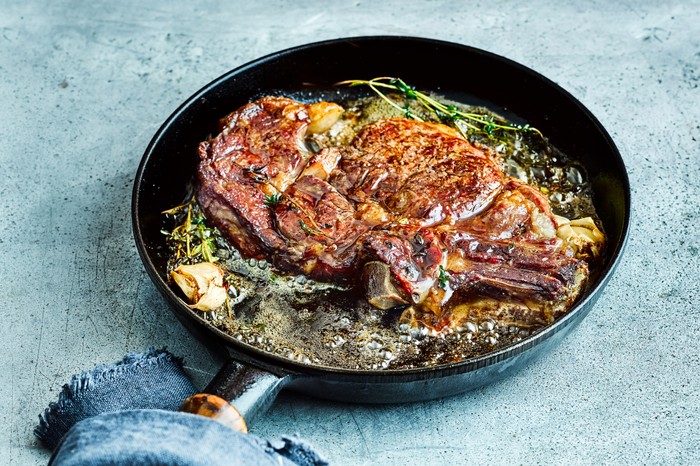 A pan full of steak and butter juices