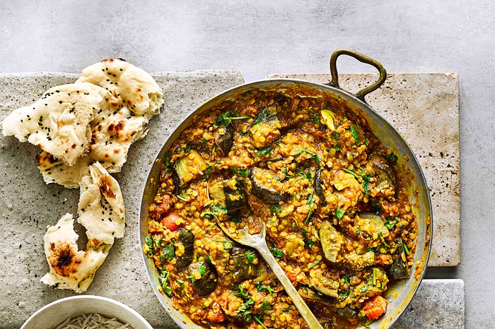 Vegan Aubergine Curry in a Large Dish with Naan Bread