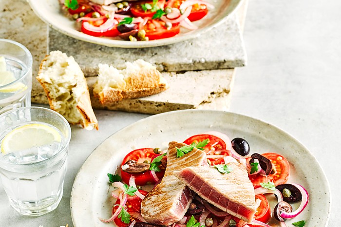 Tuna and Tomato Salad with Olives on a White Plate