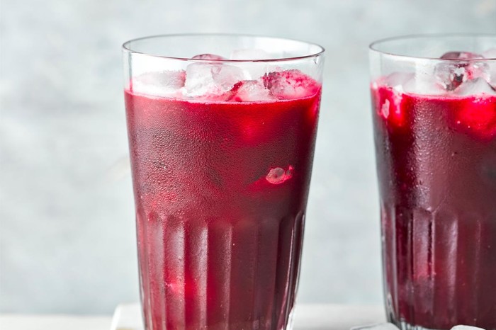 Two full glasses of beetroot, apple and ginger juice