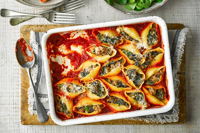 baked sausage and kale stuffed pasta shells in a oven baking dish