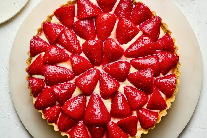 Top down view of a macerated strawberry custard tart